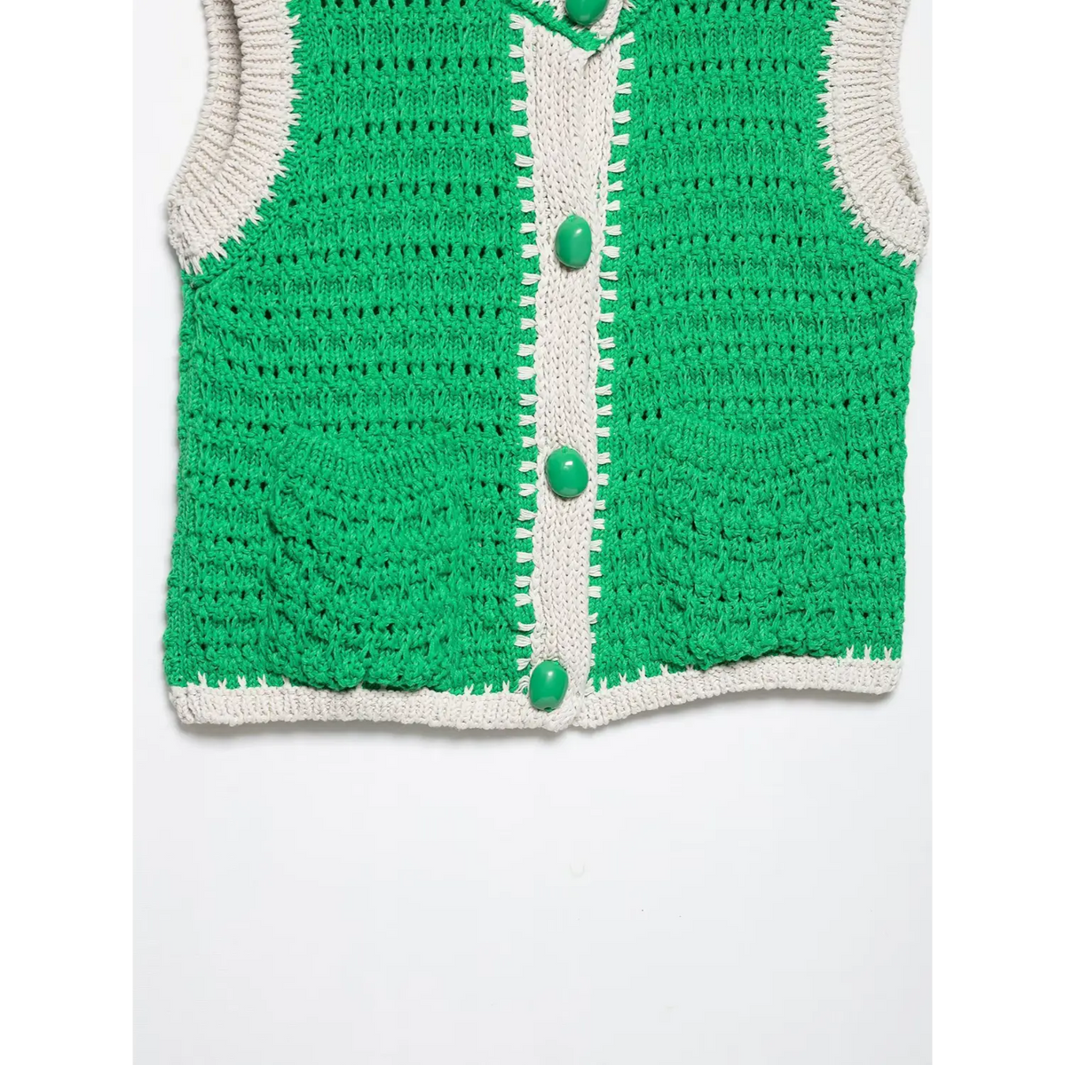 Close-up of green placket buttons and hem