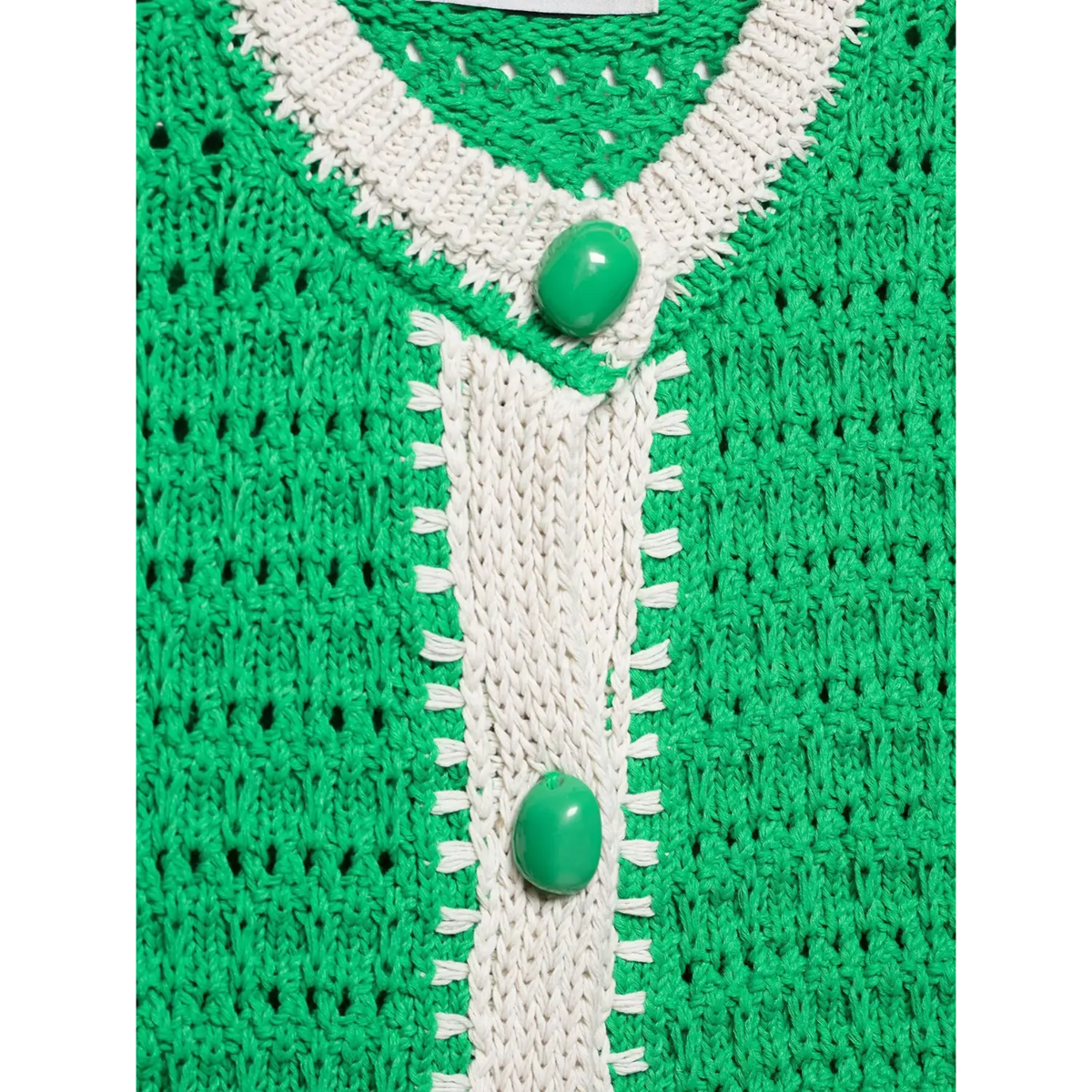 Close-up of shell stitch placket and green button