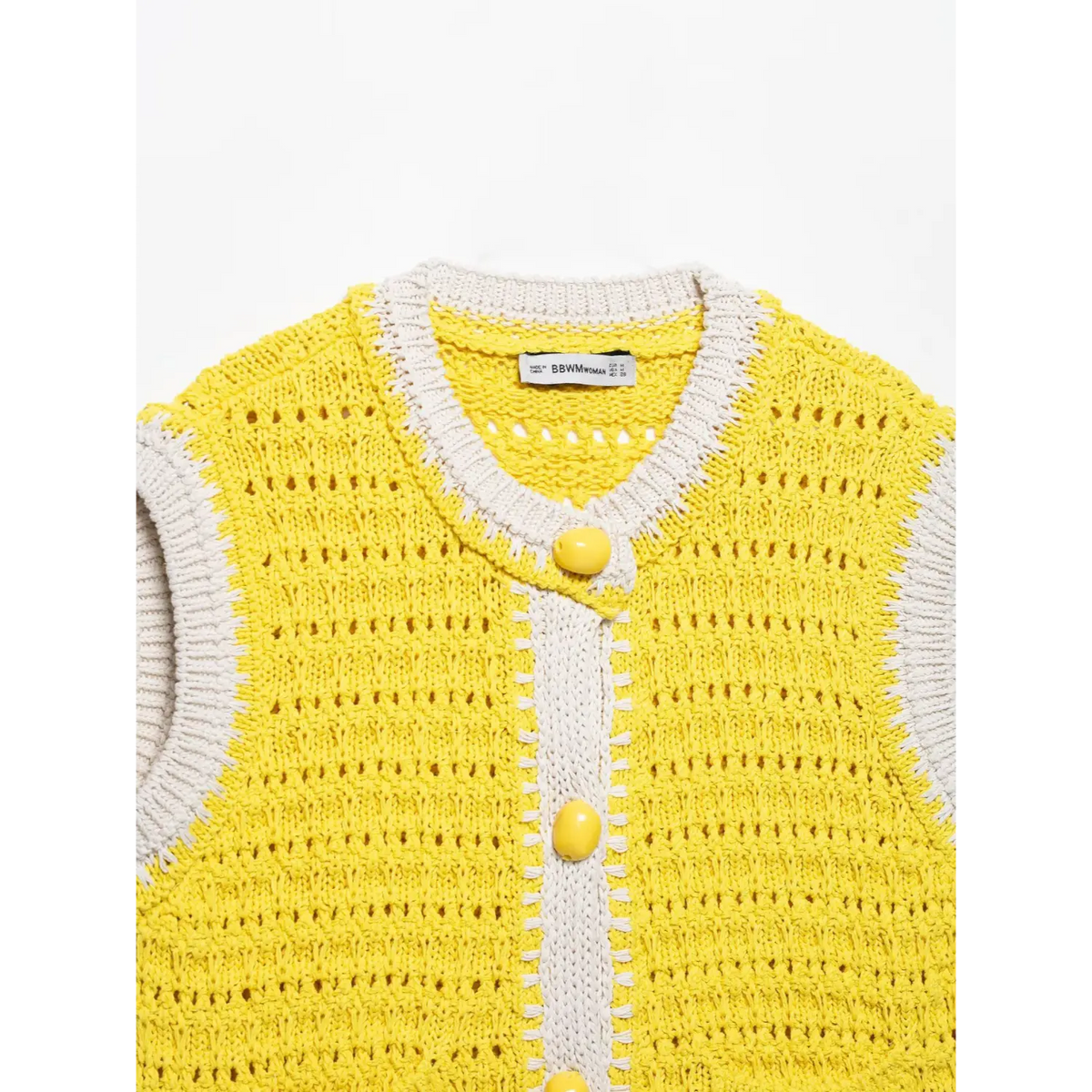 Close-up of yellow collar placket buttons