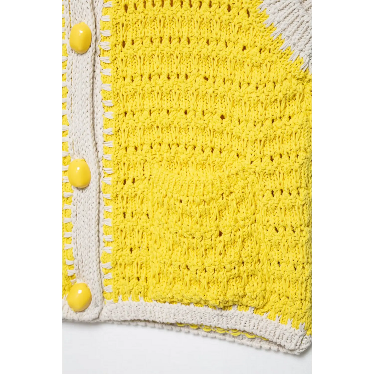 Close-up of yellow hem and placket buttons