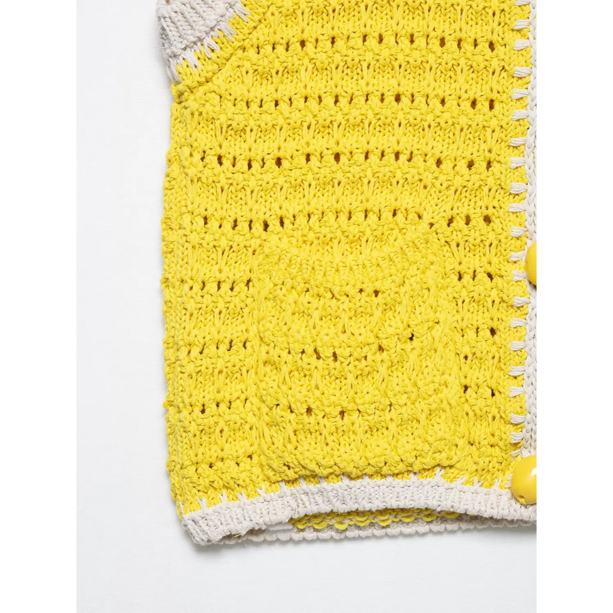 Close-up of yellow hem and placket buttons