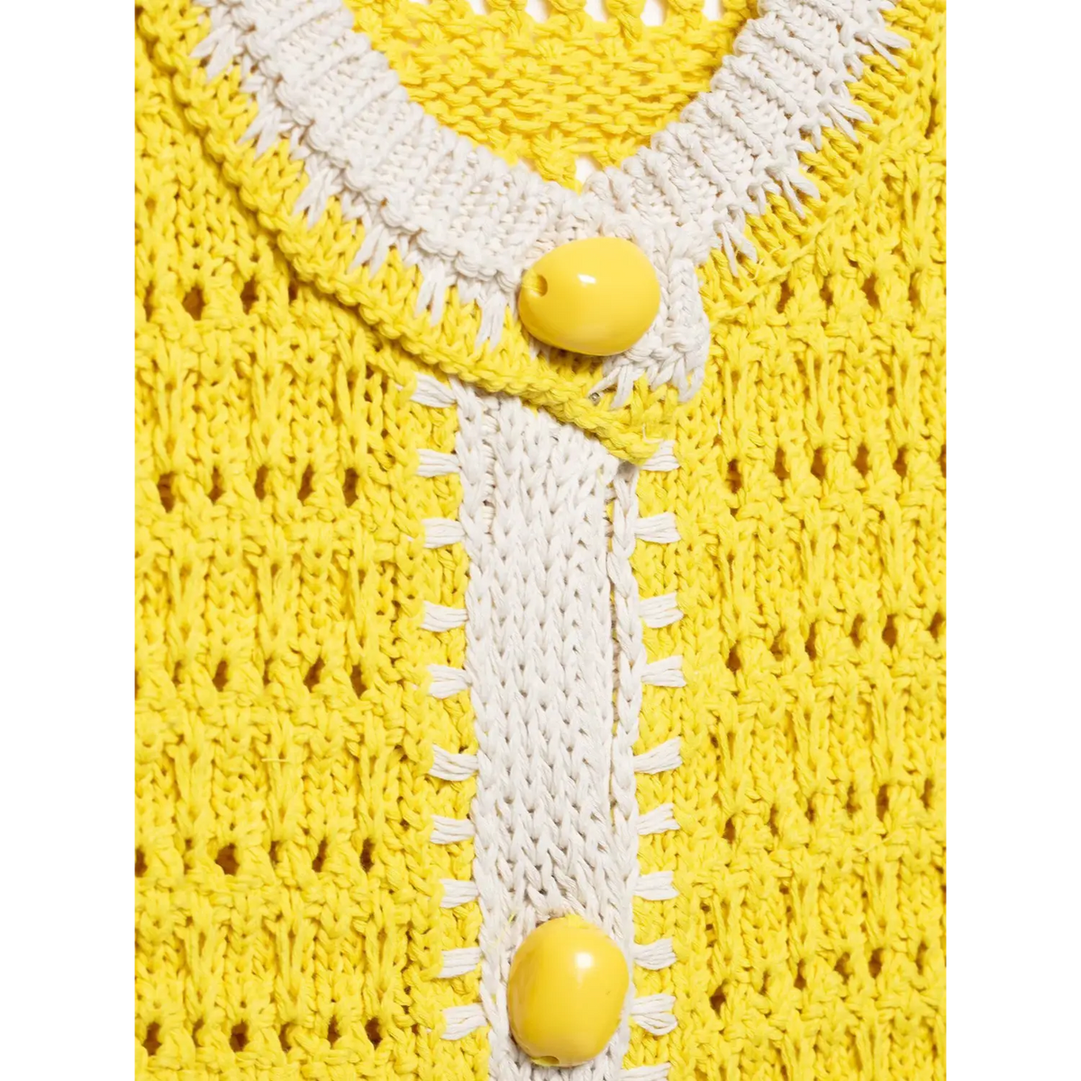Close-up of shell stitch placket and yellow button