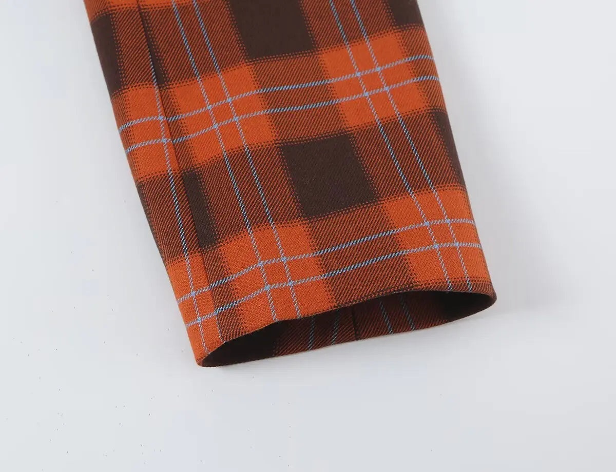 Close-up of long sleeve cuff and plaid fabric