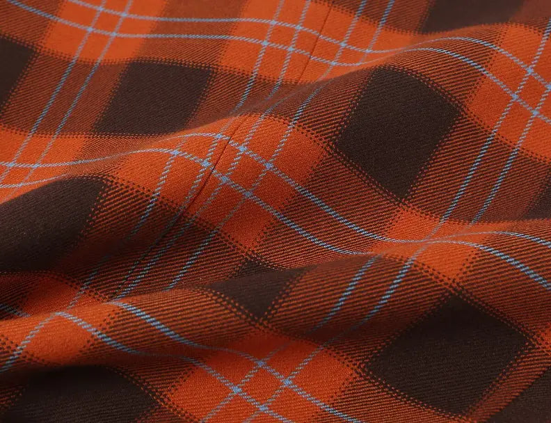 Macro close-up of orange brown plaid fabric texture