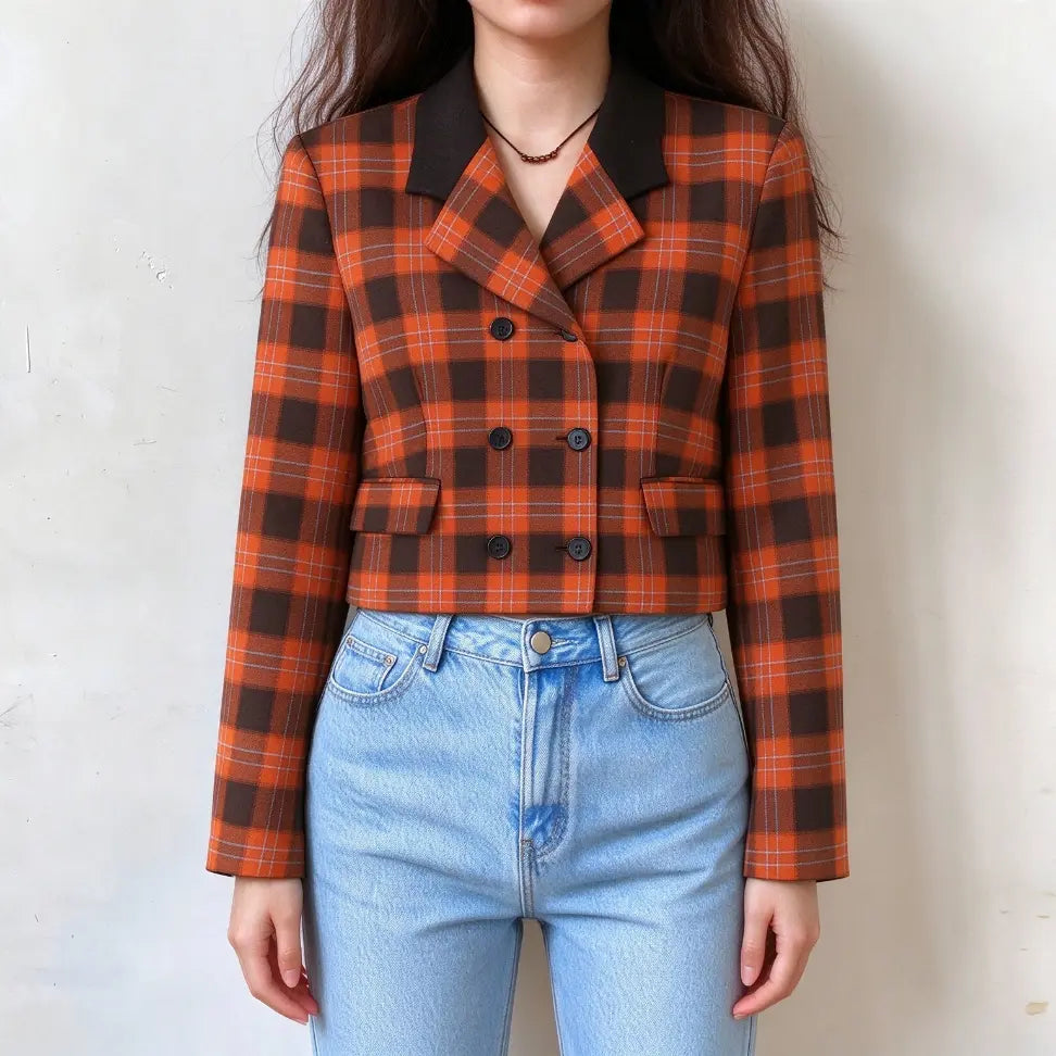 Model wearing orange brown plaid double breasted contrast lapel cropped blazer with jeans, front view