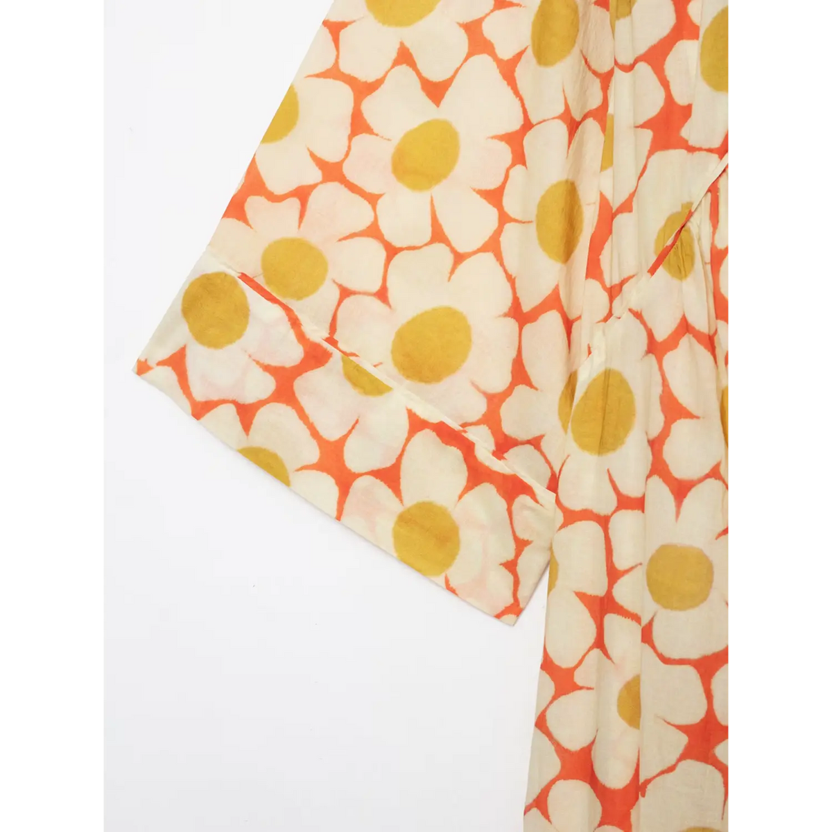 Close‑up of wide kimono sleeve cuff on orange daisy print flowy maxi dress