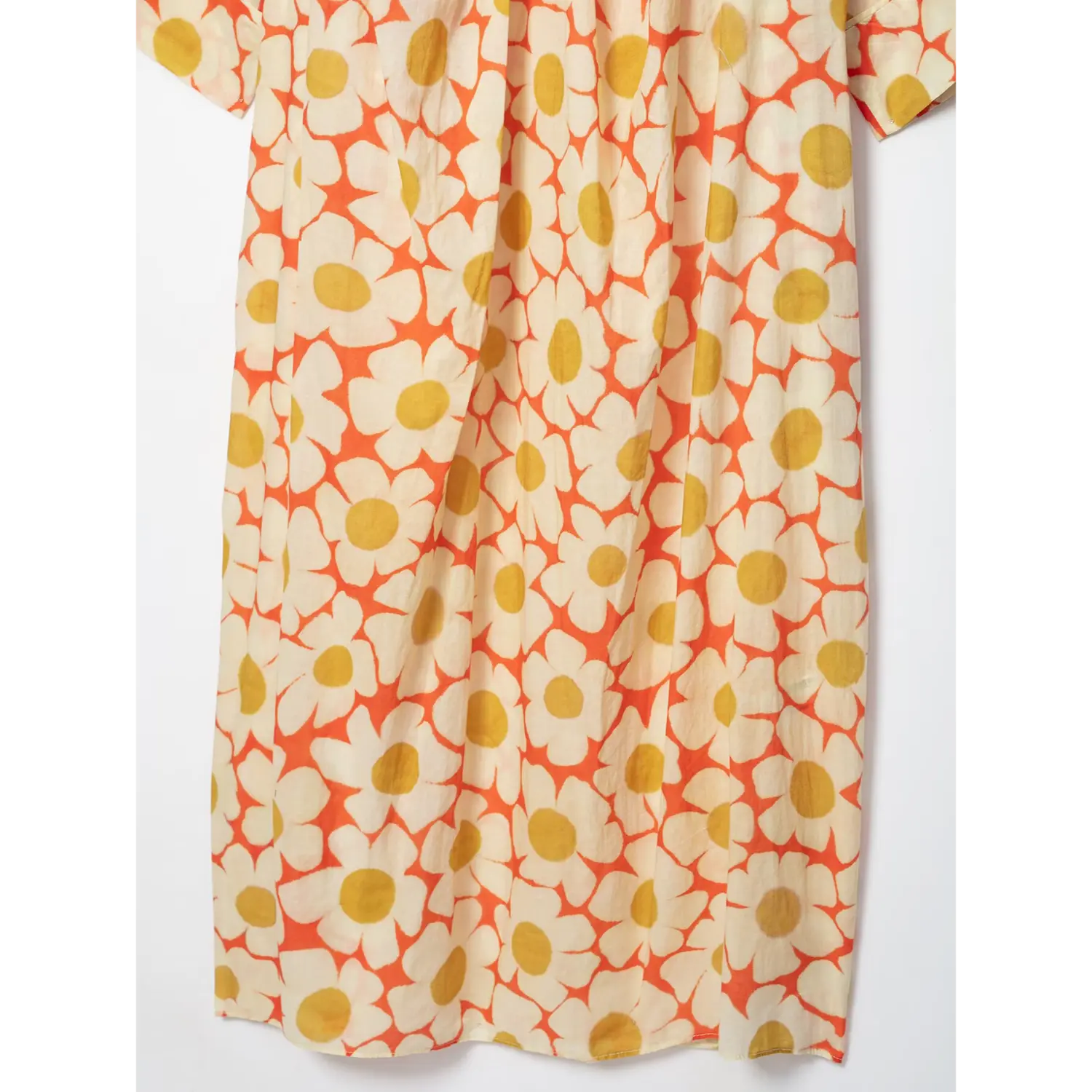 Side flat view of full skirt for orange daisy print flowy maxi dress