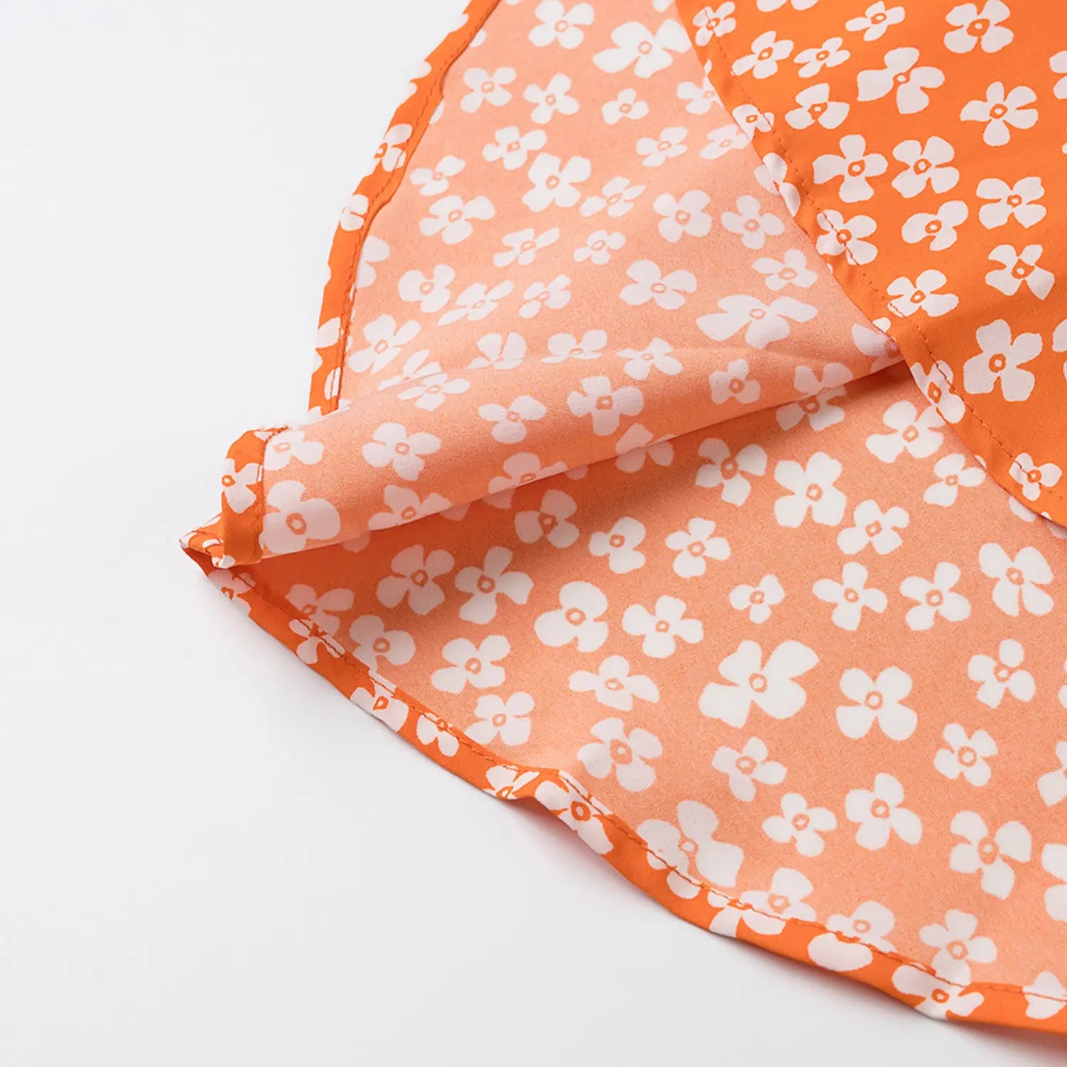 Close-up of the inner lining and hem stitching on the orange floral dress