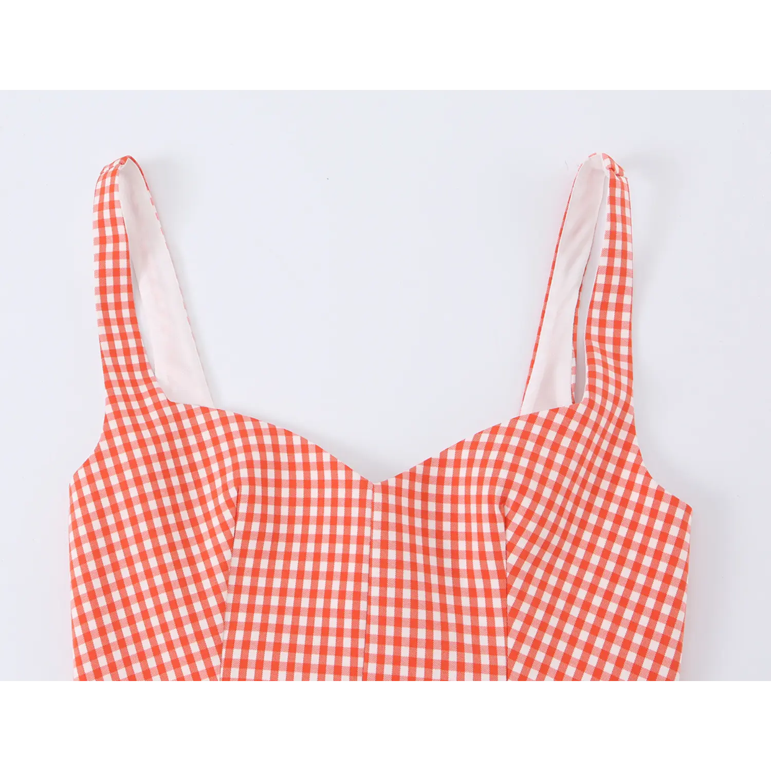 Close-up of sweetheart V neckline and wide matching gingham cami straps, vertical bust darts for shaping, orange micro gingham woven fabric