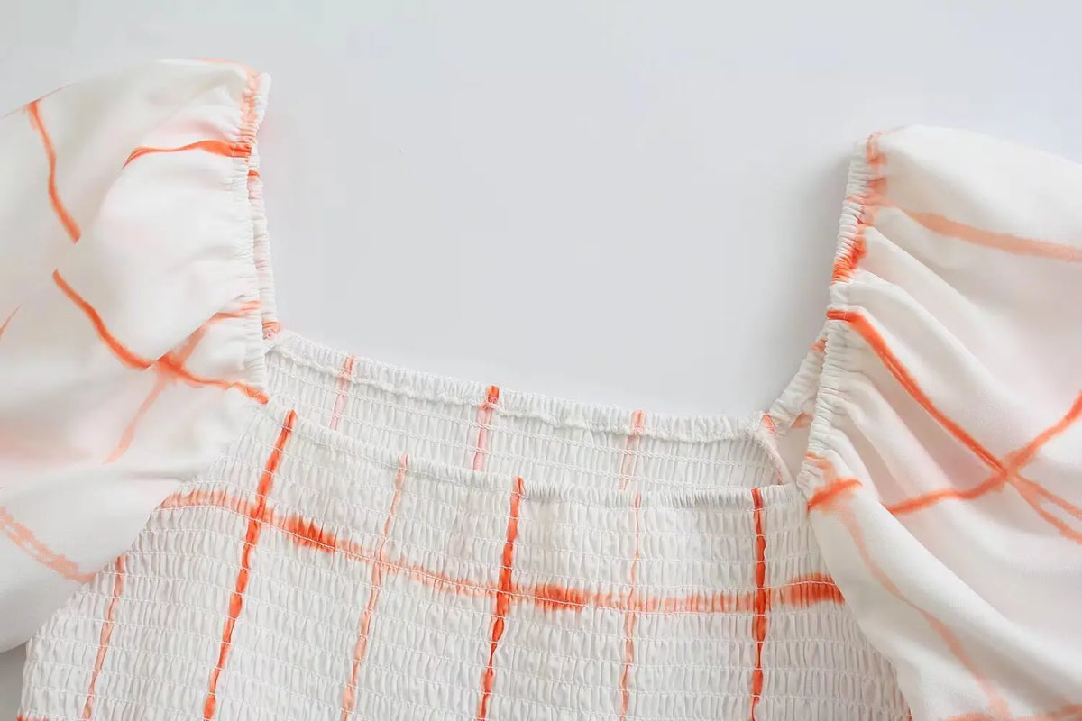 Close-up of square neckline and smocked bodice