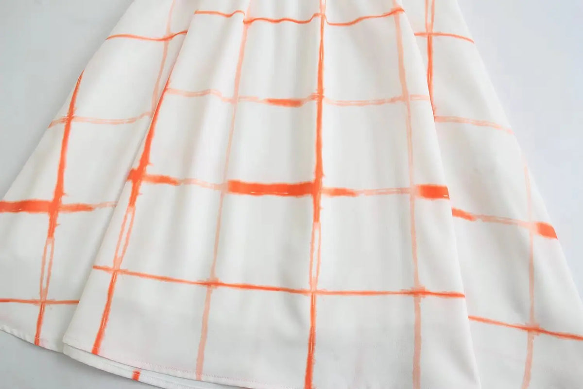 Close-up of A-line skirt and orange grid print