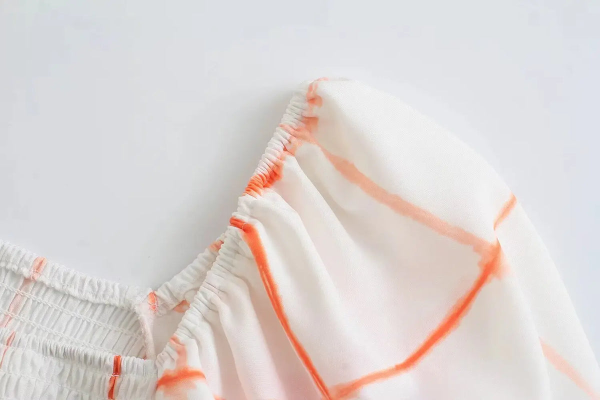 Close-up of puff sleeve elastic opening and grid print