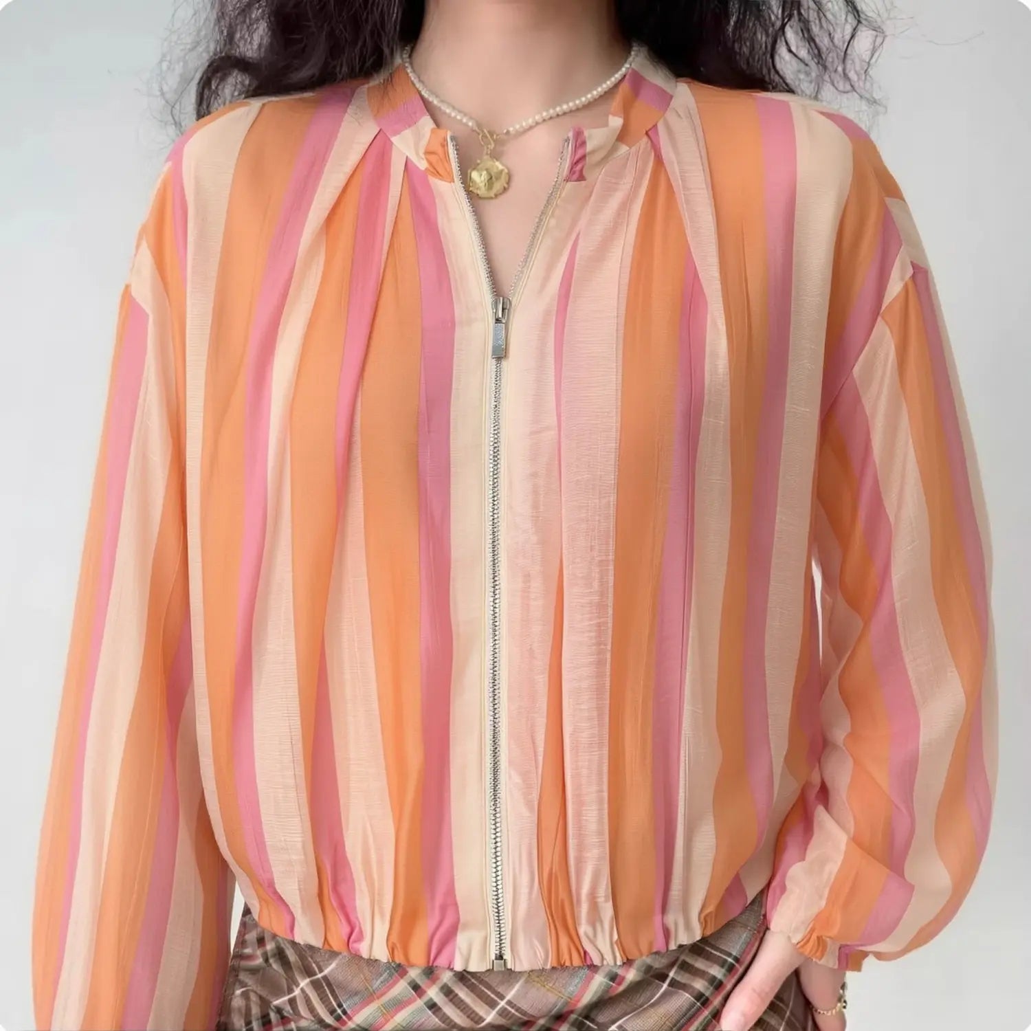 Front lifestyle shot on model, vertical stripe lightweight bomber jacket, stand collar and full zip, elastic cuffs and hem, matched with plaid bottoms, casual summer outfit