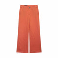 Full front flat lay of orange vertical stripe trousers, high waist single button zipper fly, side slash pockets, straight wide leg silhouette, thin dark vertical pinstripe, lightweight soft woven fabric