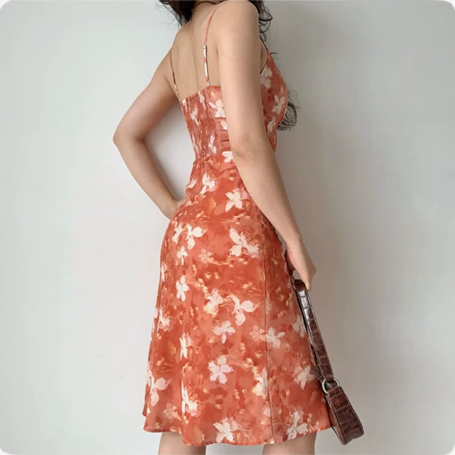Back close-up shot displaying full elastic smocked back panel and adjustable thin shoulder straps
