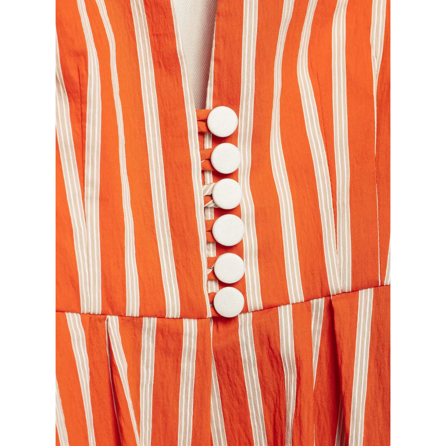 Macro close‑up front white decorative buttons on orange striped peplum blazer