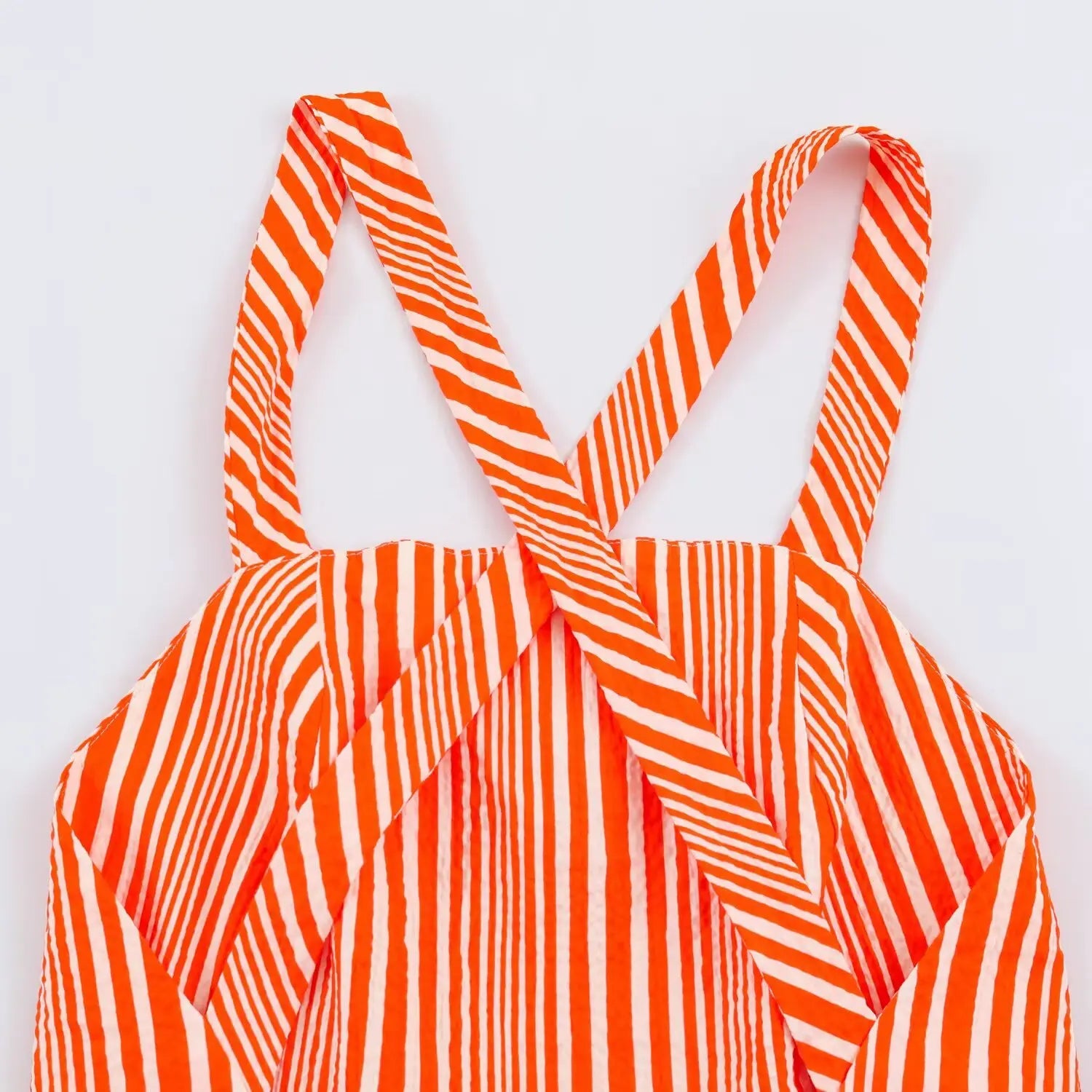 Close‑up of crisscross back straps with vertical stripe print