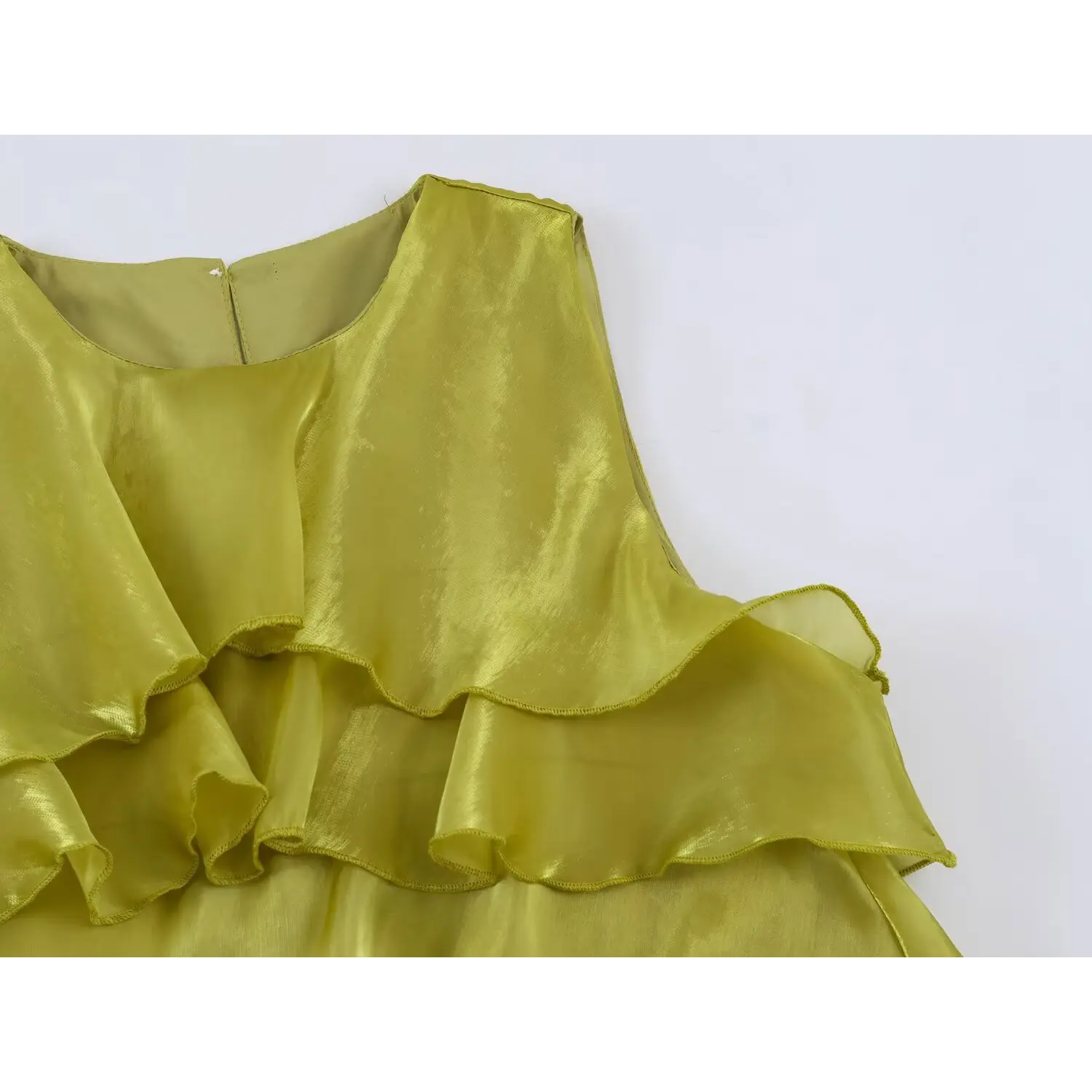 Fabric closeup, glossy organza ruffle edge stitching of chartreuse tiered long dress
