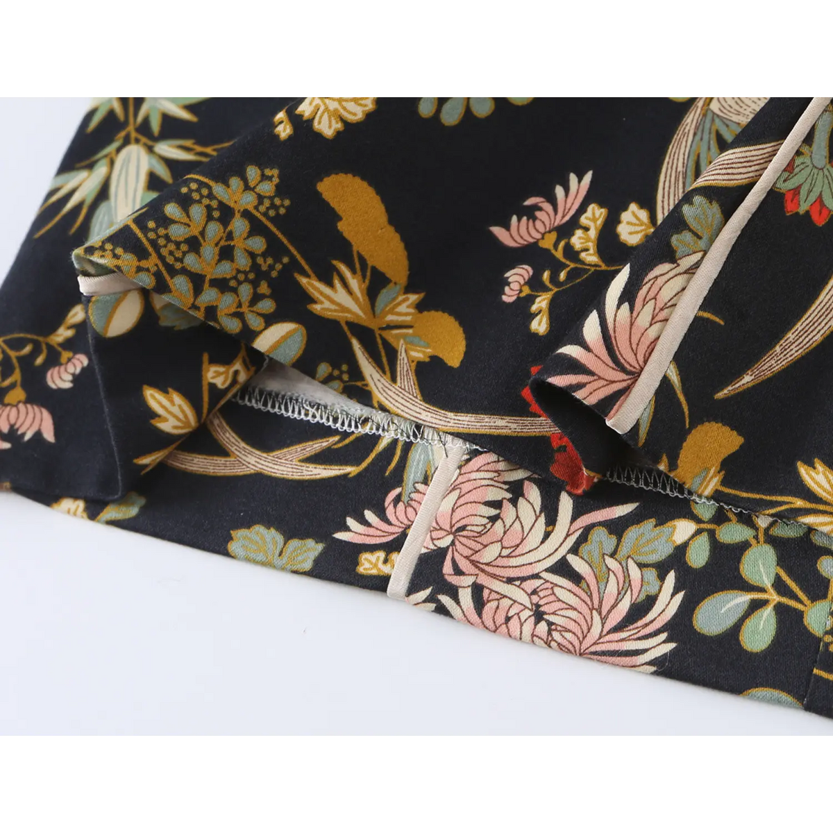Close-up of finished hem stitching on oriental floral dress