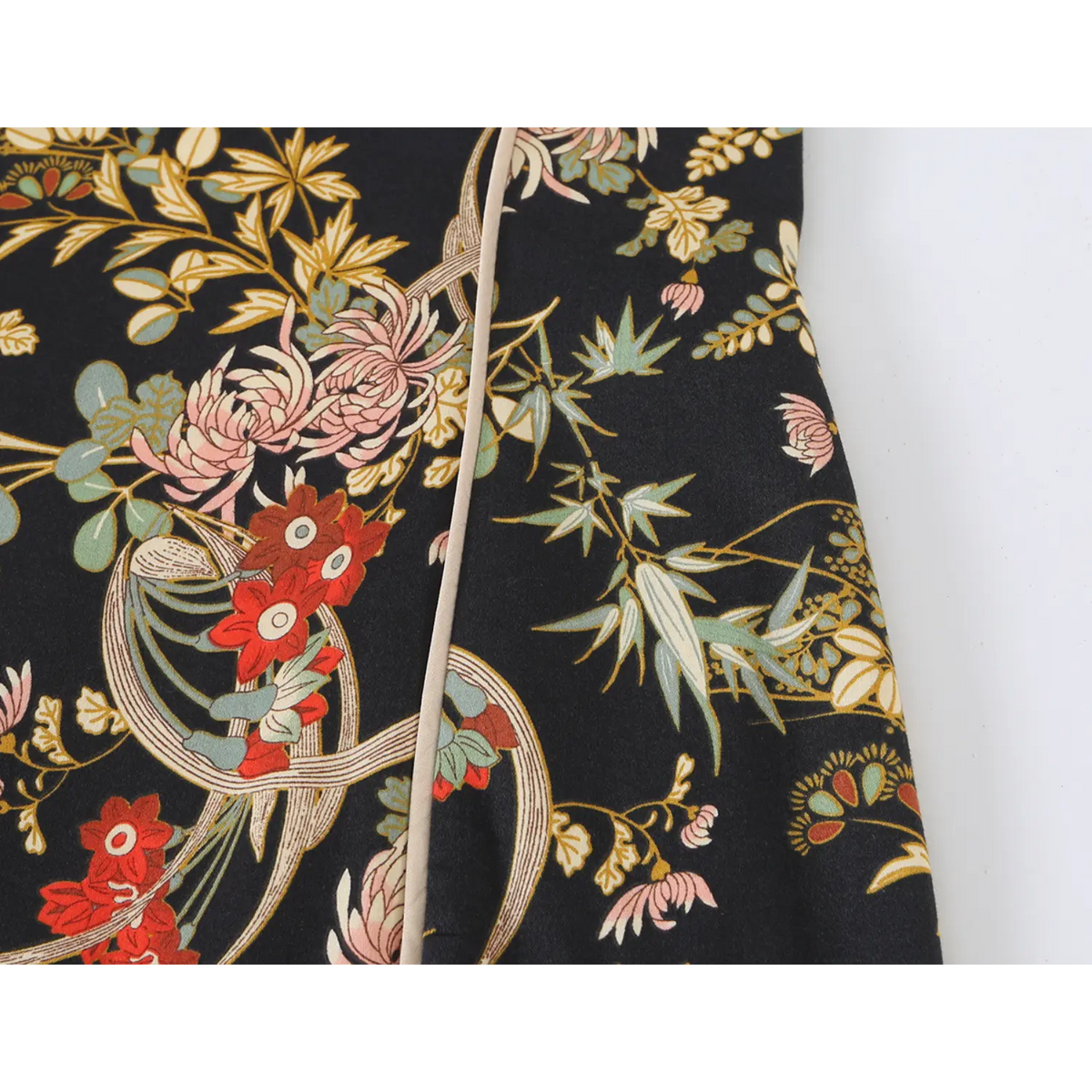 Close-up of side seam and oriental floral print with piping