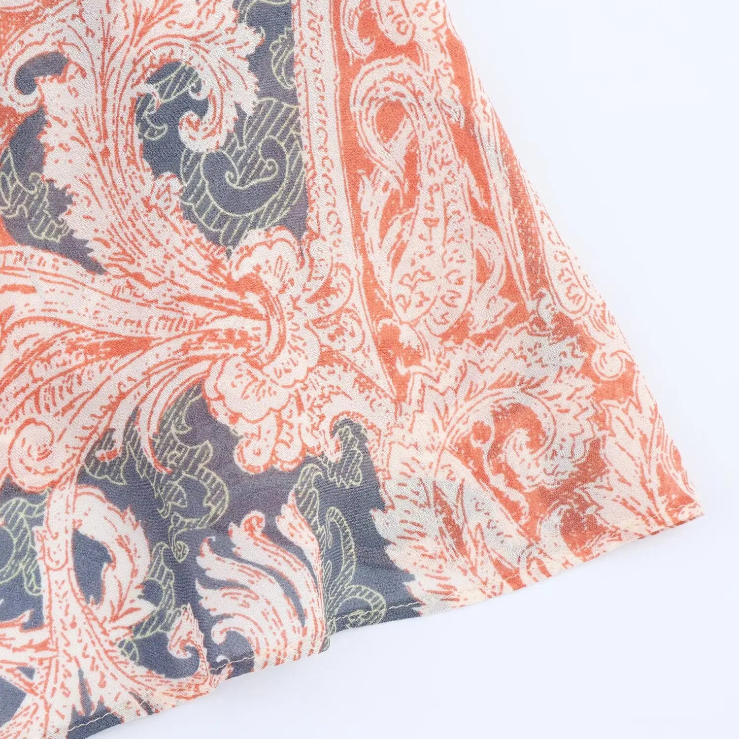 Close‑up of chiffon skirt hem, fine finished stitching, soft wavy ruffled edge