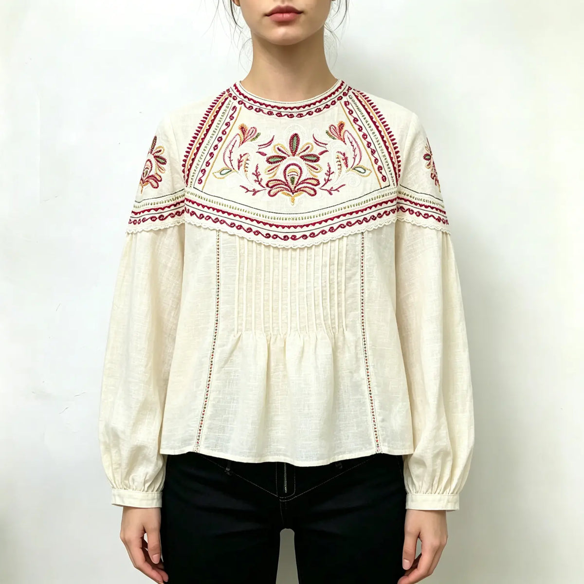Model wearing cream paisley embroidered puff sleeve peplum blouse