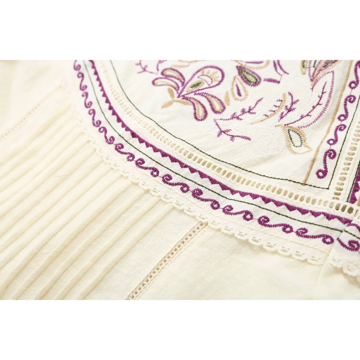 Close-up of pintuck pleats and lace edge