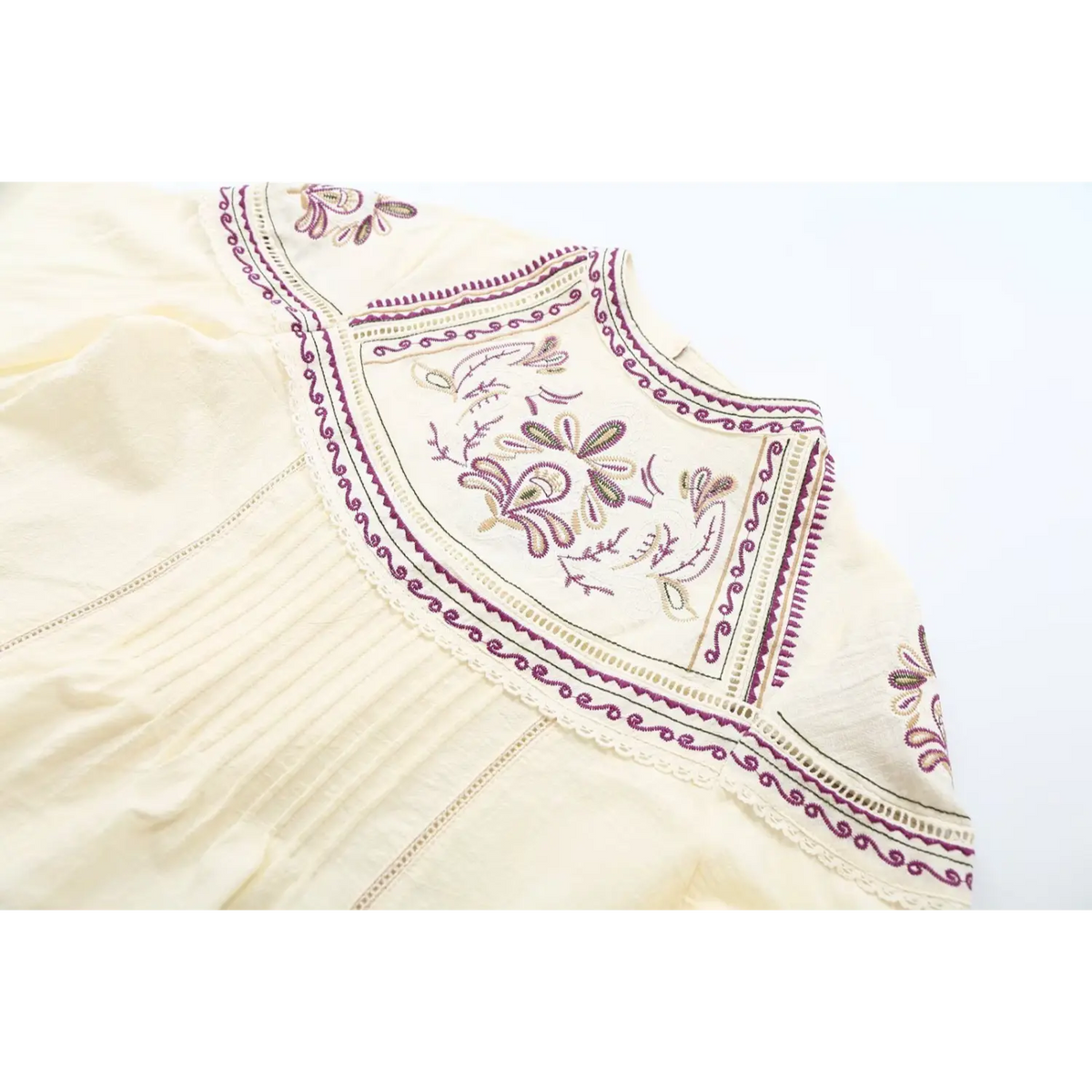 Close-up of embroidered yoke and pintuck bodice