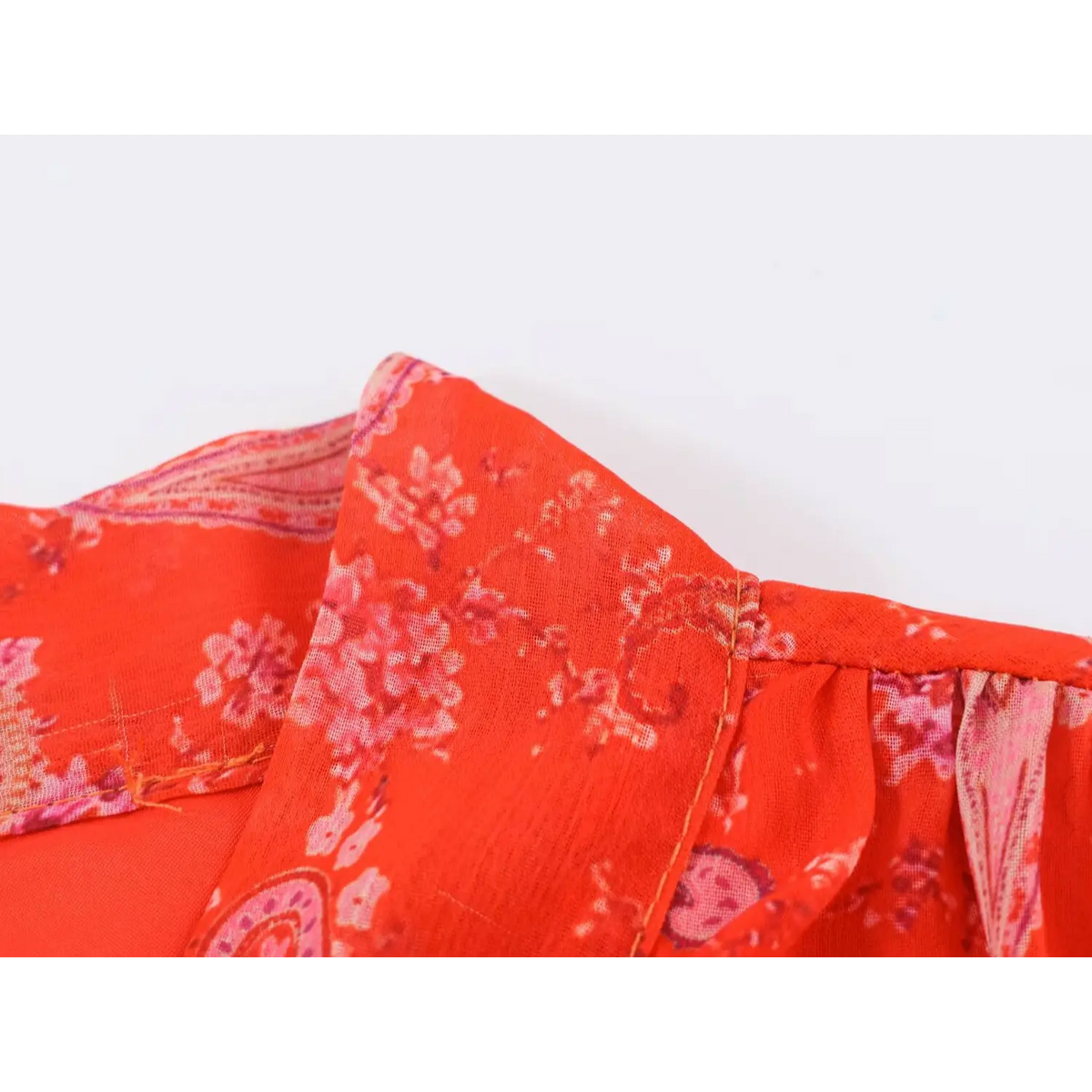 Close-up of collar seam construction on red paisley print maxi dress