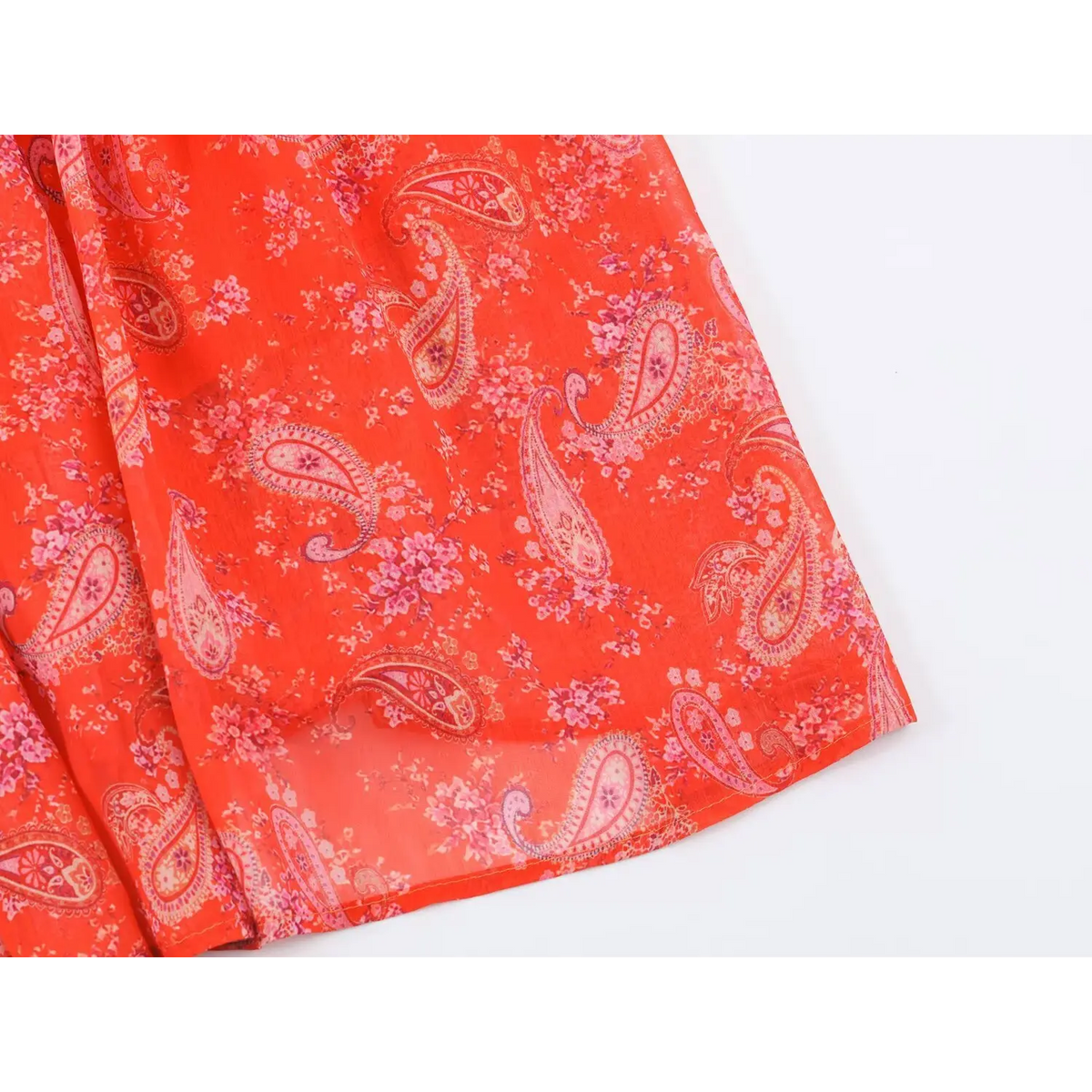 Macro shot of skirt fabric of paisley maxi dress, showing lightweight texture and allover paisley floral print