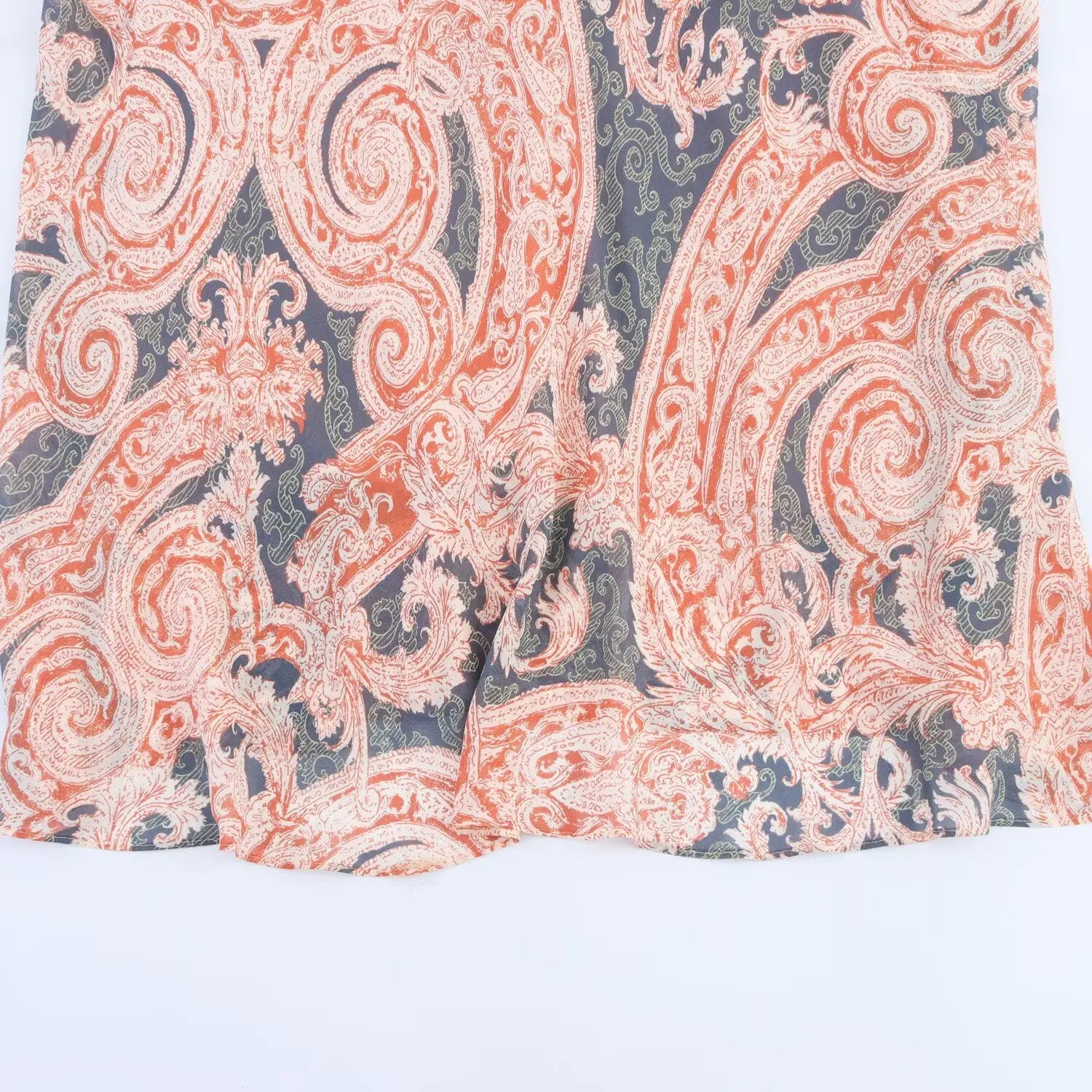 Partial shot of flowy skirt hem, vintage paisley pattern, ruffled wavy chiffon hemline