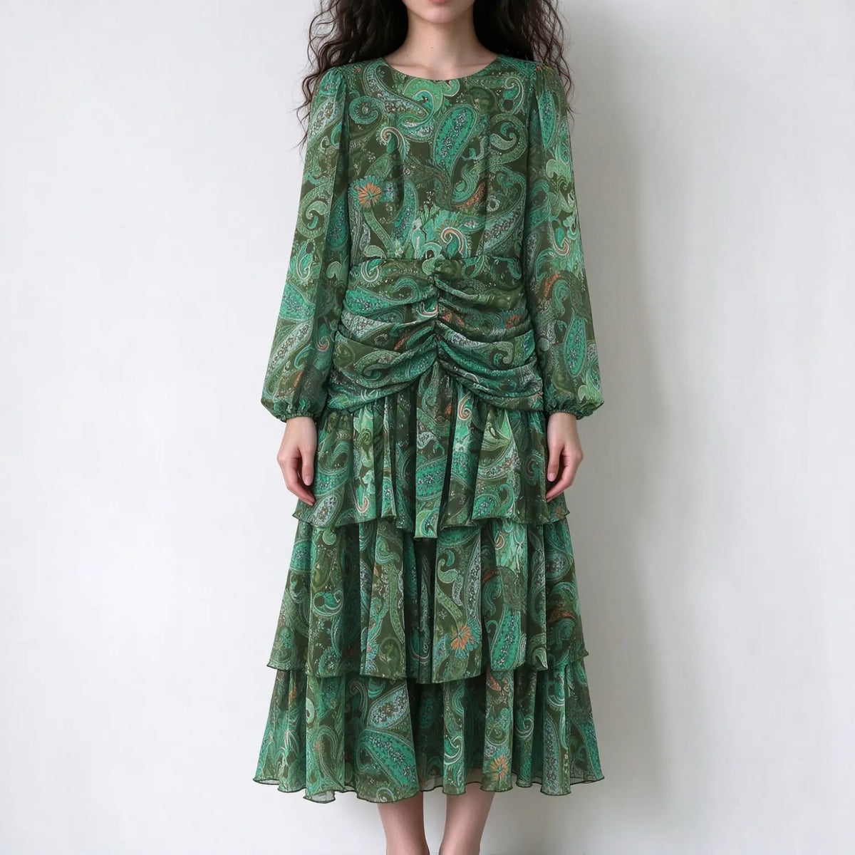 Model wearing paisley print ruched tiered midi dress, front view