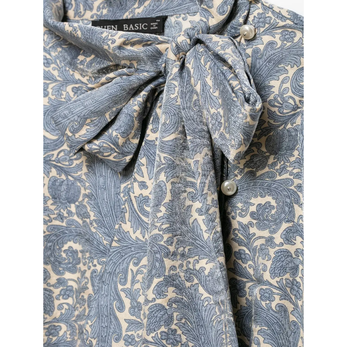 Close-up of self tie bow and side pearl buttons