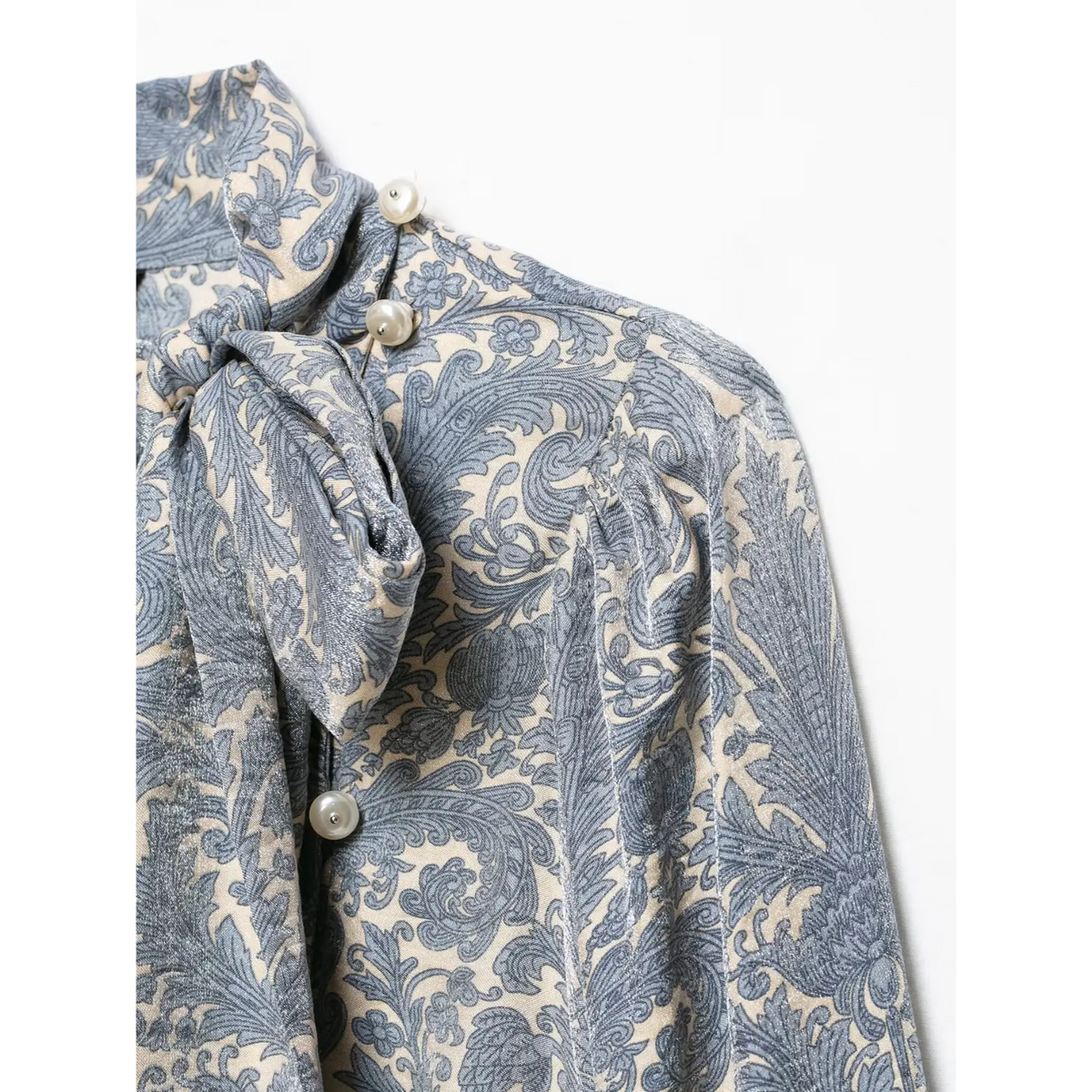 Close-up of puff shoulder and pearl buttons