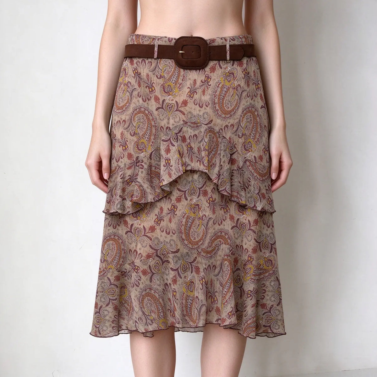 Model wearing paisley print tiered ruffle midi skirt with belt, front view