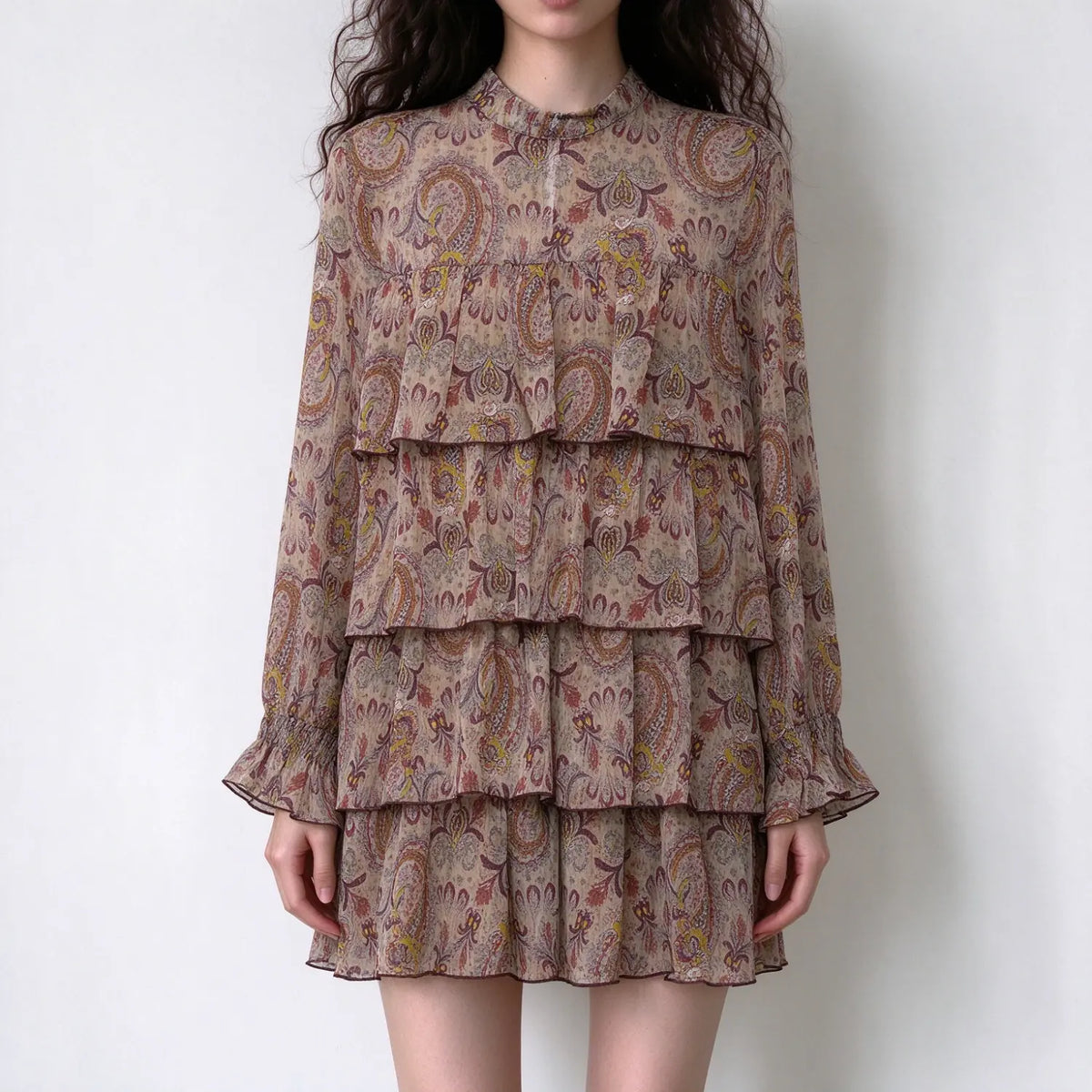 Model wearing paisley print tiered ruffle mini dress, front view