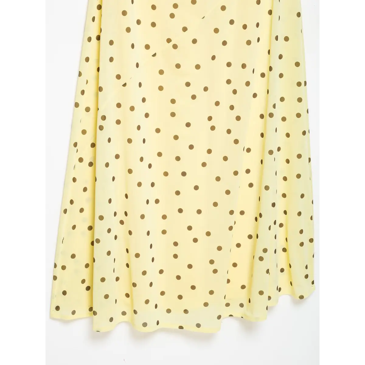 Close of flowy chiffon hem on cream brown dot sleeveless maxi dress