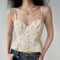 Female model wearing pale yellow purple floral corset cami top, paired with denim jeans, sweet romantic summer outfit