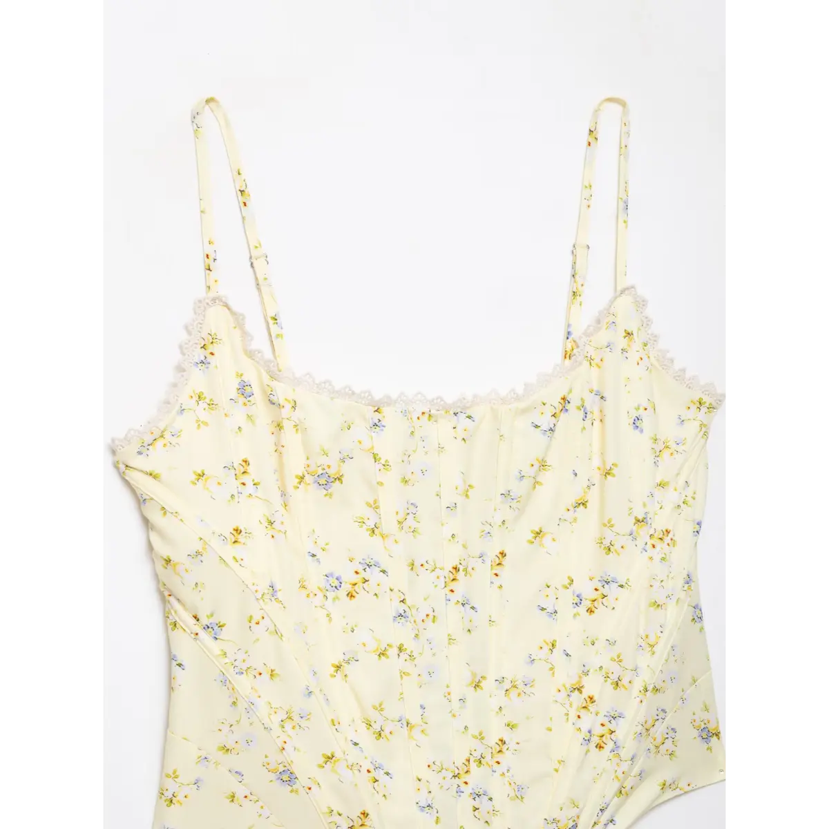 Complete front view of pale yellow floral corset top with lace trim and adjustable spaghetti straps.