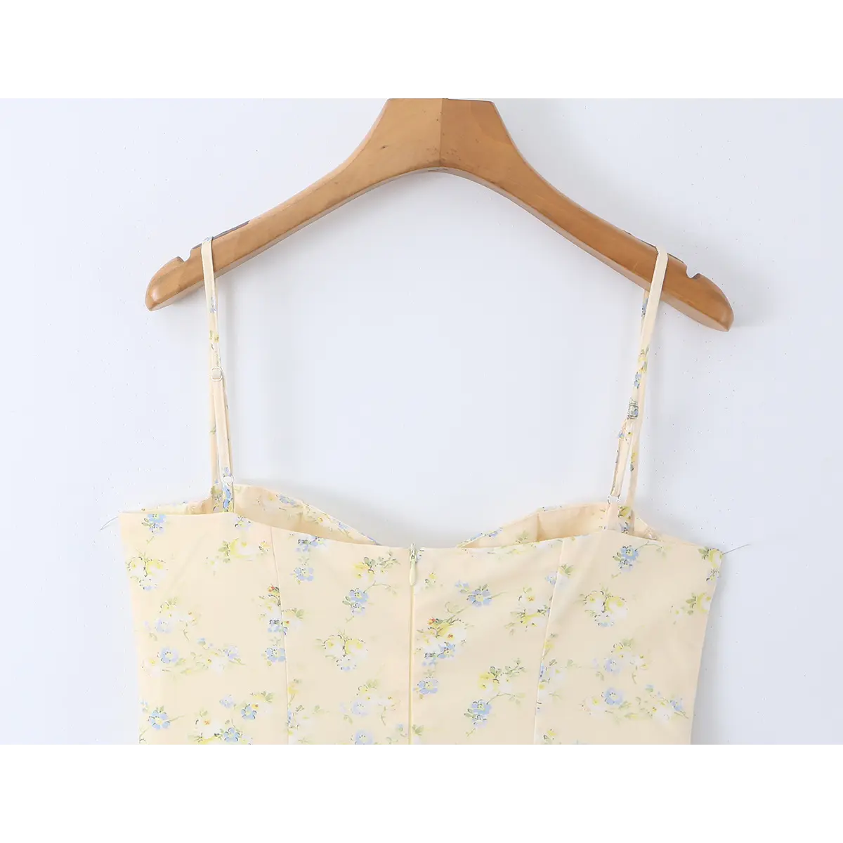 Full back view of the pale yellow floral dress, highlighting the center-back zipper closure.