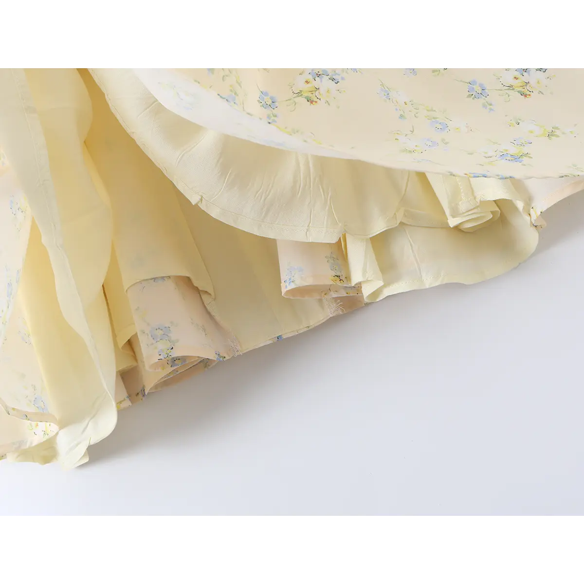Close-up of the layered construction, showing the gathered skirt and pale yellow lining.