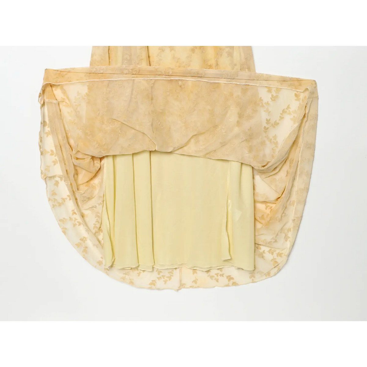 Flat lay shot showing inner lining and outer sheer mesh layer of pale yellow leaf jacquard cami maxi dress