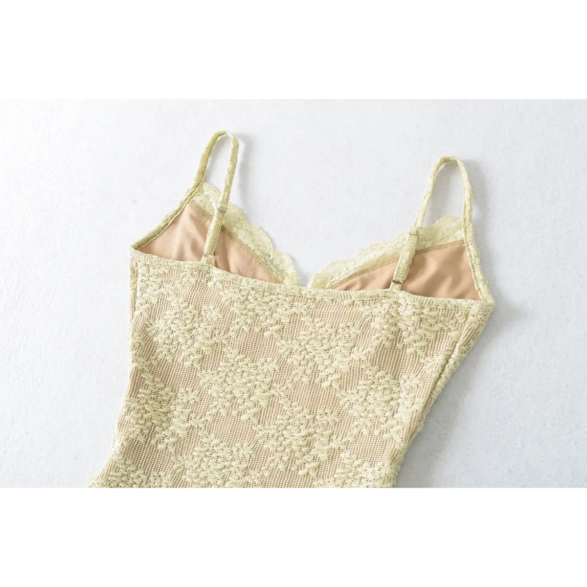 Full back shot of the pale yellow lace camisole, displaying the adjustable straps and fitted back.