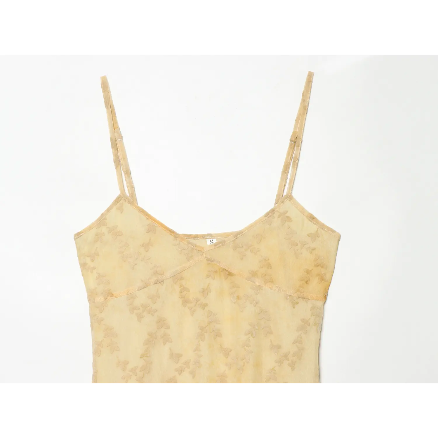 Close‑up front bodice of pale yellow leaf jacquard mesh maxi dress, v‑neckline, adjustable spaghetti straps, leaf pattern mesh fabric
