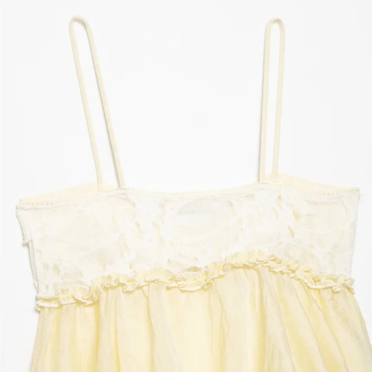 Back view of pale yellow ruffled camisole, showing the lace bodice and thin spaghetti straps
