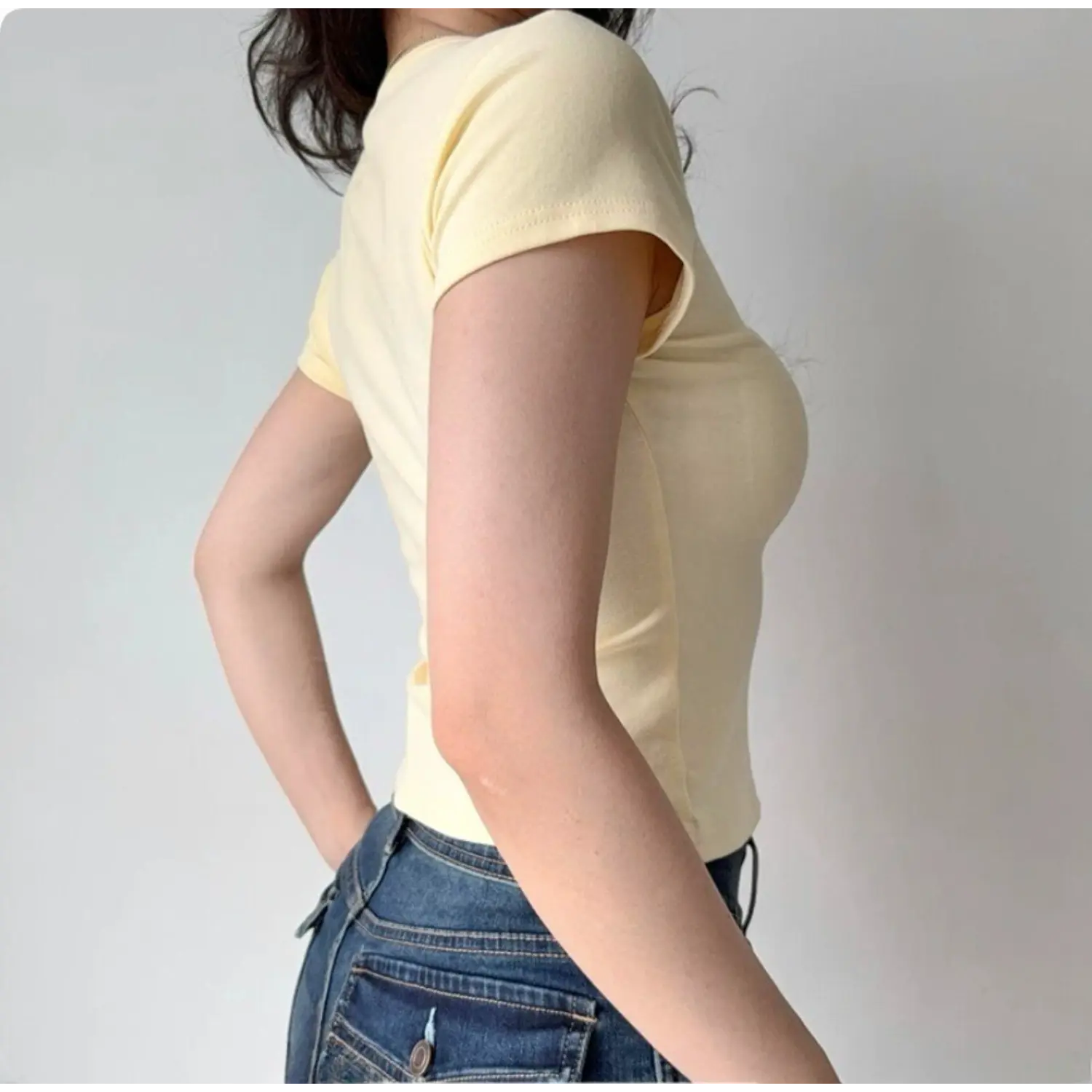 Side back view of pale yellow solid stretch cropped t shirt, slim fitted short sleeve round neck casual women basic tee