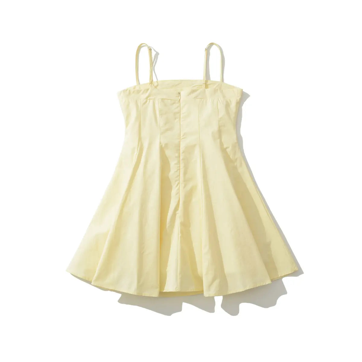 Back view of a pale yellow spaghetti strap dress, showing the hidden center zipper, adjustable straps, and flared A-line skirt.