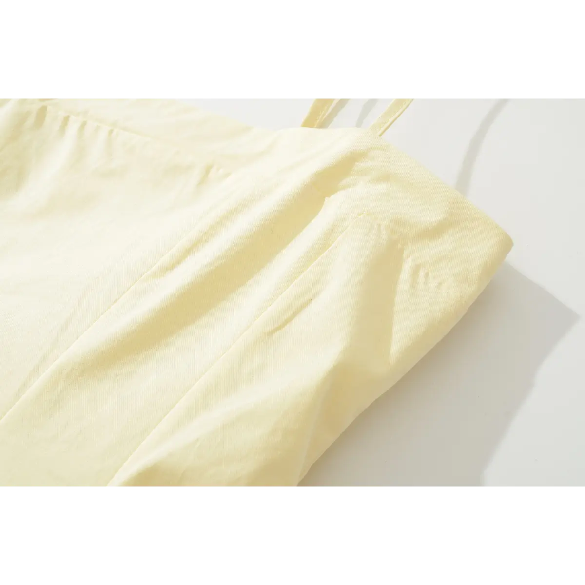 Close-up of the dress's square neckline, showing the structured seam lines and princess seam construction.