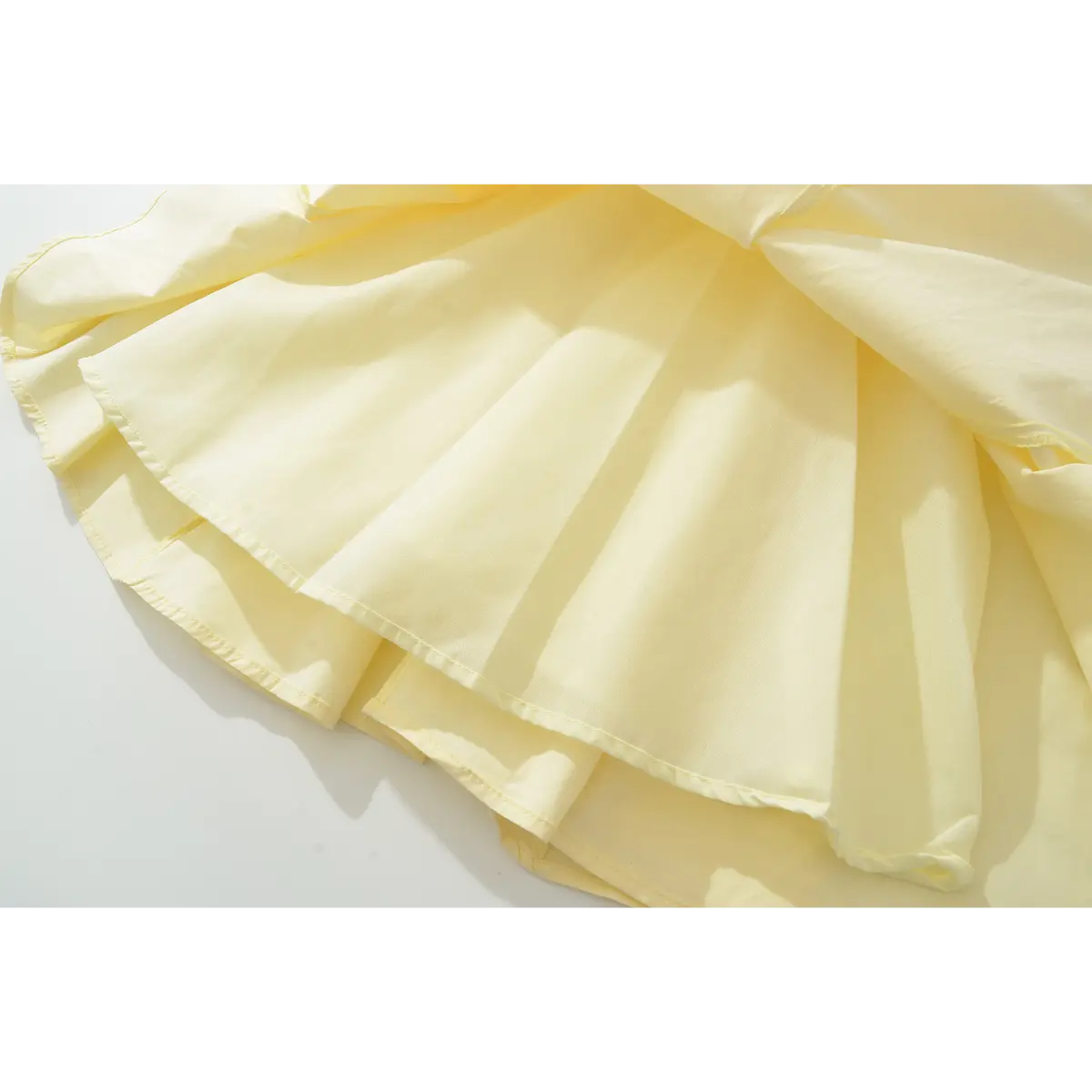 Close-up of the dress's skirt, showing the inner lining, seam allowances, and how the fabric flares out.