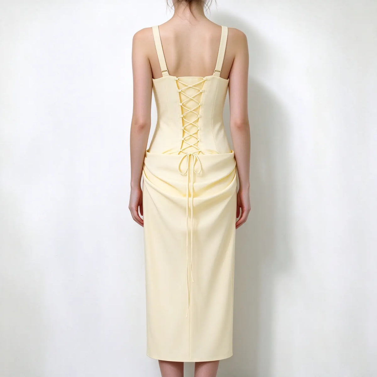 Model back view, pale yellow square strap maxi dress, lace-up corset back with tie string, draped waist maxi skirt